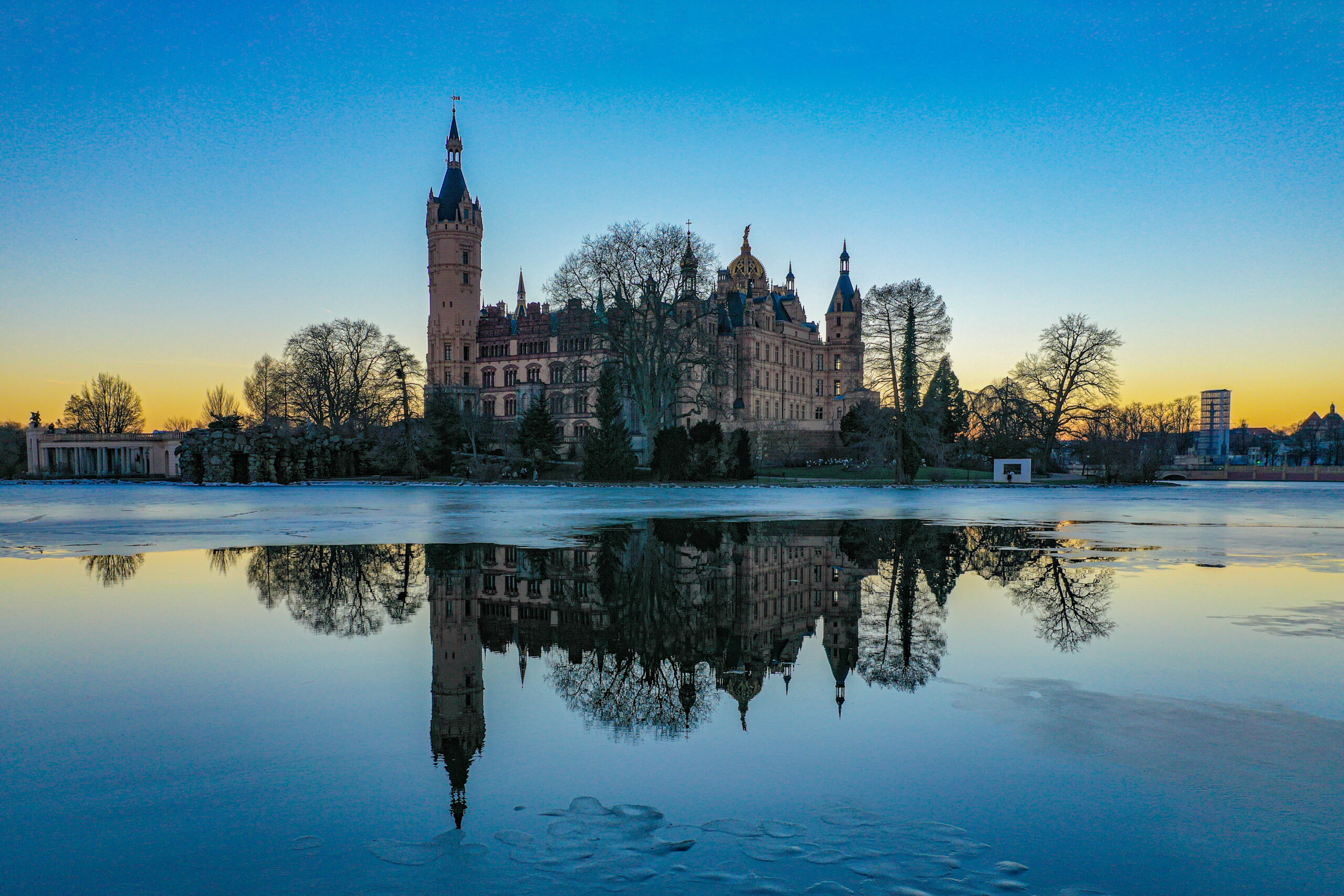 Schwerin von oben 2 a castle with a tower and a body of water