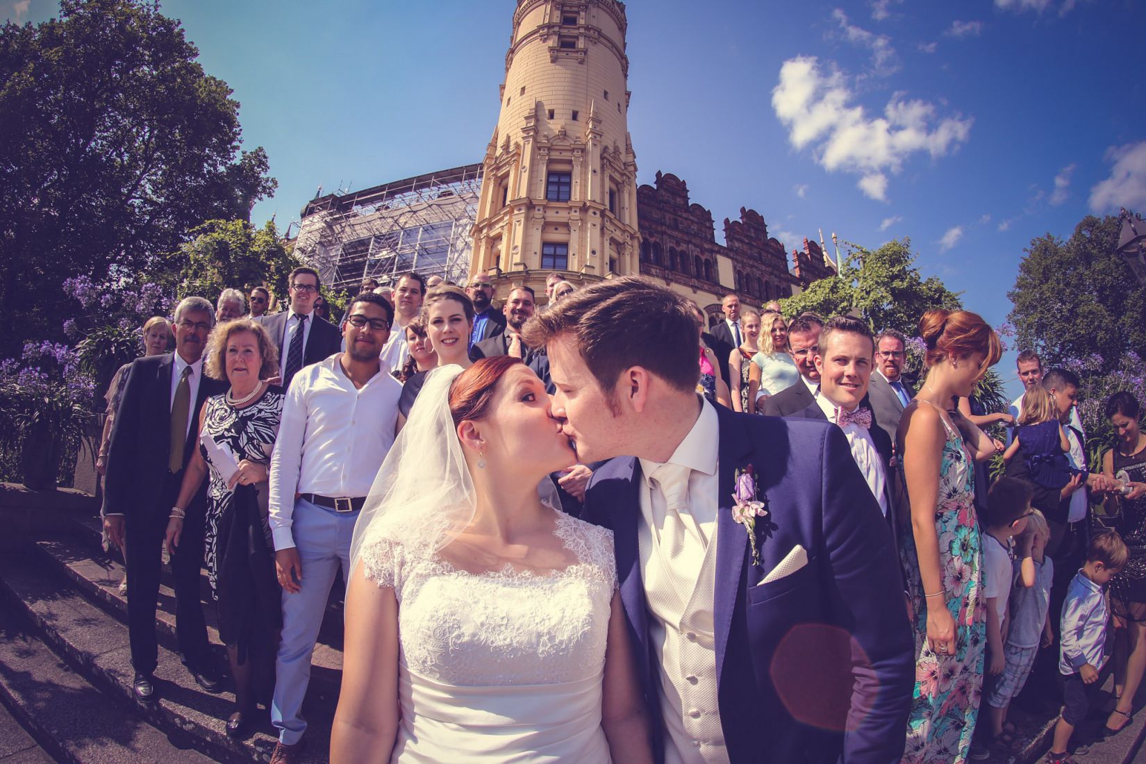 10421568305ccb3b908443b4.54377513_prowedaward-brian-lorenzo a bride and groom kissing in front of a crowd of people